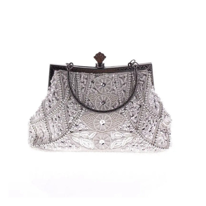 Bolsa clutch prata com detalhes em pedrarias bordadas e estrutura metálica vintage - loja Bolsa Clutch