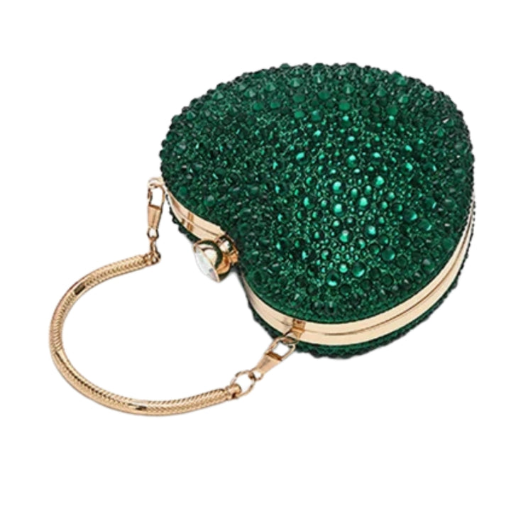 Bolsa clutch festa Verde em formato de coração, cravejada com cristais azuis vibrantes, alça metálica dourada estruturada e fecho superior com detalhe em pedra – loja Bolsa Clutch